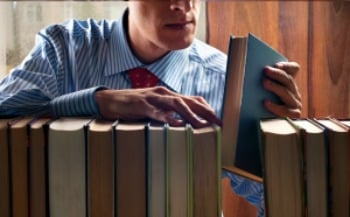 Man filing books in library. Featured on MarketResearch.com www.blog.marketresearch.com {What if a Market Research Report Doesn’t Answer My Question}.