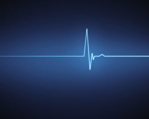 Blue ECG heartbeat on black background