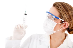 Friendly female doctor with a needle - isolated over white-1