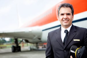 Handsome airplane pilot at the airport smiling