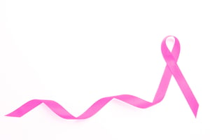 Pink awareness ribbon with trail on white background