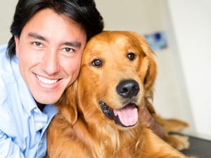 Portrait of a happy man with a dog at the vet