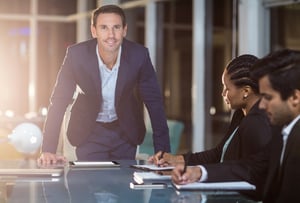 Portrait of businessman with coworkers in a meeting in the conference room