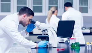 Science student working with microscope in the lab at the university