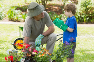 View of a grandfather and grandson engaged in gardening