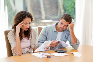 Young couple calculating their domestic bills at home